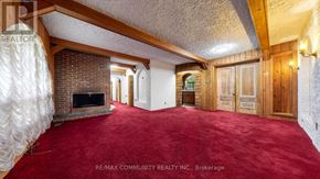 Toronto (Scarborough Village) apartment for rent - A room with a red carpet and wooden walls.