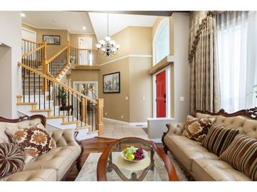 Surrey apartment for rent - A living room with a brown couch and a glass coffee table.