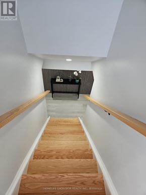 Brantford apartment for rent - A staircase with wooden steps and white walls.