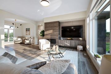 Winnipeg apartment for rent - A modern living room with a white sofa set and a fireplace.