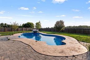 Winnipeg apartment for rent - A small kidney-shaped pool with a brick border.