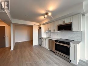 Pickering (Bay Ridges) condo for rent - A modern kitchen with white cabinets and stainless steel appliances.