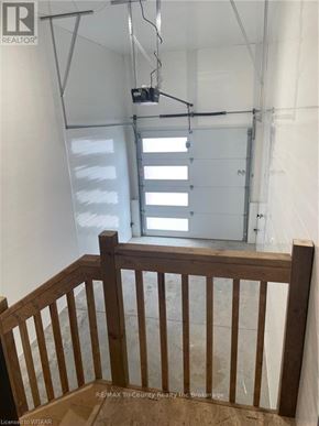 Tillsonburg condo for rent - A room with a wooden railing and a window with blinds.