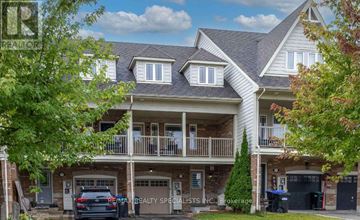 Innisfil (Alcona) townhouse for rent - A large house with a balcony and a car parked in front.
