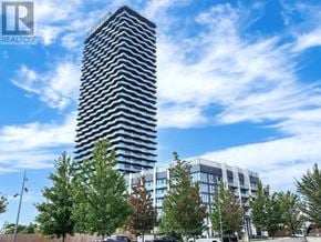 Toronto (Islington-City Centre West) condo for rent - A tall building with a striped pattern is the focal point of the image.