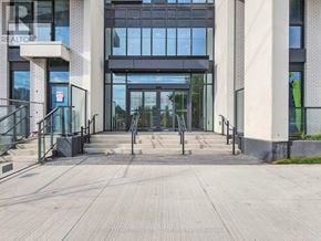 Toronto (Islington-City Centre West) condo for rent - The entrance to a building with a glass door and a metal railing.
