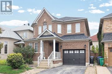 Mississauga (Churchill Meadows) apartment for rent - A house with a garage and a driveway in front of it.
