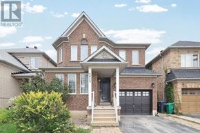 Mississauga (Churchill Meadows) apartment for rent - A large brick house with a front porch and two garages.
