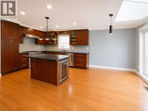 Vancouver apartment for rent - A large kitchen with wooden cabinets and a center island.