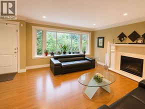 Vancouver apartment for rent - A living room with a black leather couch, a glass coffee table, and a fireplace.