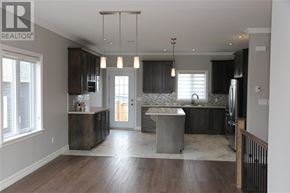 St. John's apartment for rent - A modern kitchen with dark wood cabinets and a central island.