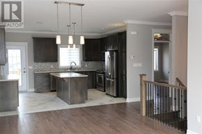 St. John's apartment for rent - A modern kitchen with dark wood cabinets and a center island.