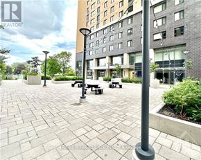 Ottawa condo for rent - A courtyard with a bench and a lamp post.