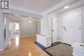 Burlington (Brant) multi-family for rent - A room with white walls and a wooden floor with a rug in front of a door.