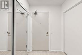 Toronto (Humber Heights) condo for rent - Three white doors in a hallway with a brokerage sign on the wall.