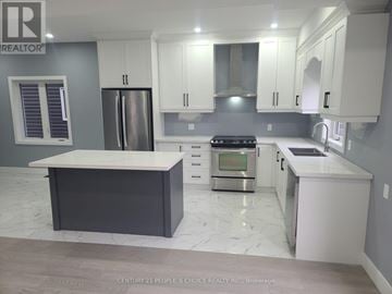 Hamilton (Mcquesten) apartment for rent - A modern kitchen with white cabinets and a marble countertop.