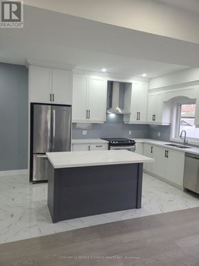 Hamilton (Mcquesten) apartment for rent - A modern kitchen with a large island and stainless steel appliances.