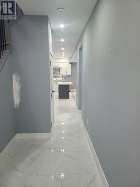 Hamilton (Mcquesten) apartment for rent - A long hallway with marble floors and white walls.