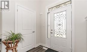 Centre Wellington (Fergus) townhouse for rent - A white door with a glass panel and a decorative design on the door handle.