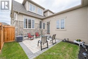 Centre Wellington (Fergus) townhouse for rent - A house with a patio and chairs.