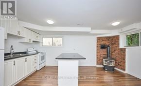 St. Catharines (Burleigh Hill) apartment for rent - A kitchen with a brick wall and a wood stove.