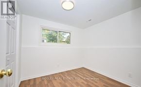 St. Catharines (Burleigh Hill) apartment for rent - A room with a door, window, and wooden floor.