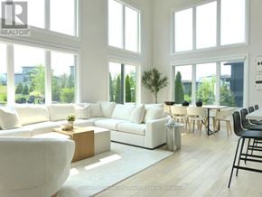 Blue Mountains apartment for rent - A white couch with a flat screen TV mounted above it in a bright room.