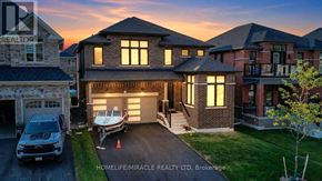 Innisfil (Lefroy) apartment for rent - A house with a garage and a car parked in front of it.