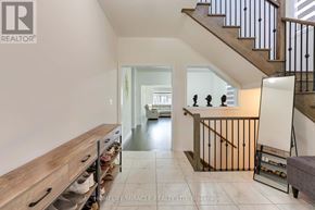 Innisfil (Lefroy) apartment for rent - A spacious hallway with a staircase and a bench.