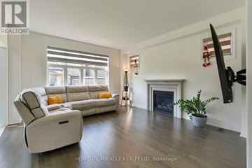 Innisfil (Lefroy) apartment for rent - A living room with a white couch and a fireplace.