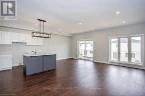 London South (South W) townhouse for rent - A spacious room with a kitchen island and wooden floors.