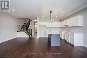 London South (South W) townhouse for rent - A spacious kitchen with white cabinets and a dark wood floor.