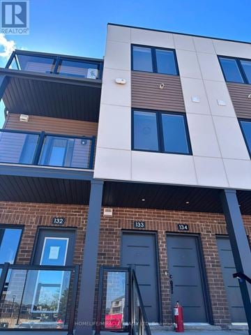 Guelph (Clairfields/Hanlon Business Park) townhouse for rent - A modern building with the number 132 on it.