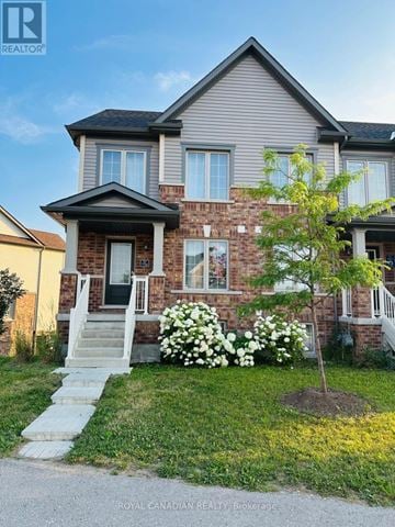 Cambridge townhouse for rent - A house with a tree in front of it.