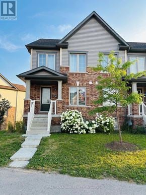 Cambridge townhouse for rent - A house with a tree in front of it.