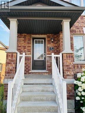 Cambridge townhouse for rent - A house with a black front door and white railings.