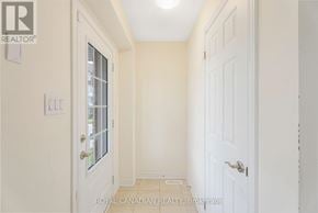 Cambridge townhouse for rent - A white door with a window and a light switch on the wall.