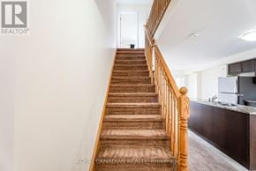 Cambridge townhouse for rent - A staircase with wooden steps and railings leads to a doorway.