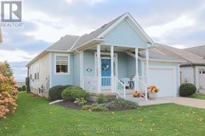 Lincoln (Lincoln-Jordan/Vineland) apartment for rent - A blue house with a white porch and a sign that says RE/MAX Niagara Realty Ltd, Brokerage.