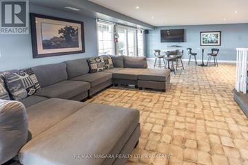 Lincoln (Lincoln-Jordan/Vineland) apartment for rent - A living room with a grey couch and a tiled floor.
