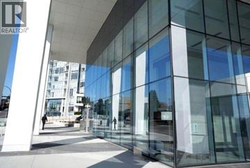 Burnaby apartment for rent - A glass building with a REALTOR sign on the top left.