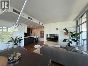 Burnaby apartment for rent - A modern living room with a grey couch and a black coffee table.