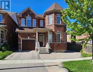 Markham (Wismer) apartment for rent - A large brick house with a garage and a front porch.