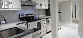 Markham (Wismer) apartment for rent - A kitchen with white cabinets and a black stove top oven.