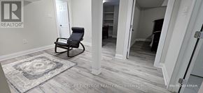 Markham (Wismer) apartment for rent - A room with a rocking chair and a rug in the middle of the floor.