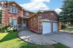 New Tecumseth (Beeton) apartment for rent - A brick house with a white garage door and a driveway.