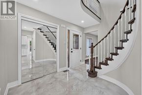 New Tecumseth (Beeton) apartment for rent - A spacious foyer with a marble floor and a curved staircase.