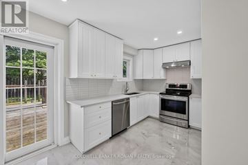 New Tecumseth (Beeton) apartment for rent - A white kitchen with a dishwasher and oven built into the counter.