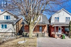 Toronto (Oakwood Village) apartment for rent - A tree in front of a house with a sign that says "ELITE ESTATE Emery".