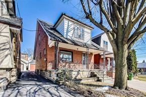 Toronto (Oakwood Village) apartment for rent - A red brick house with a white window and a tree in front.